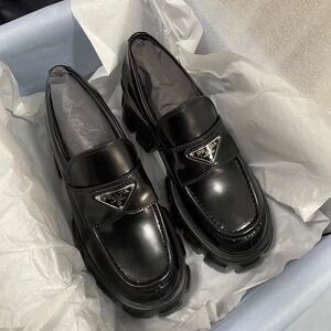 Prada Black Patent Leather Lug Sole Loafers with Triangle Plaque